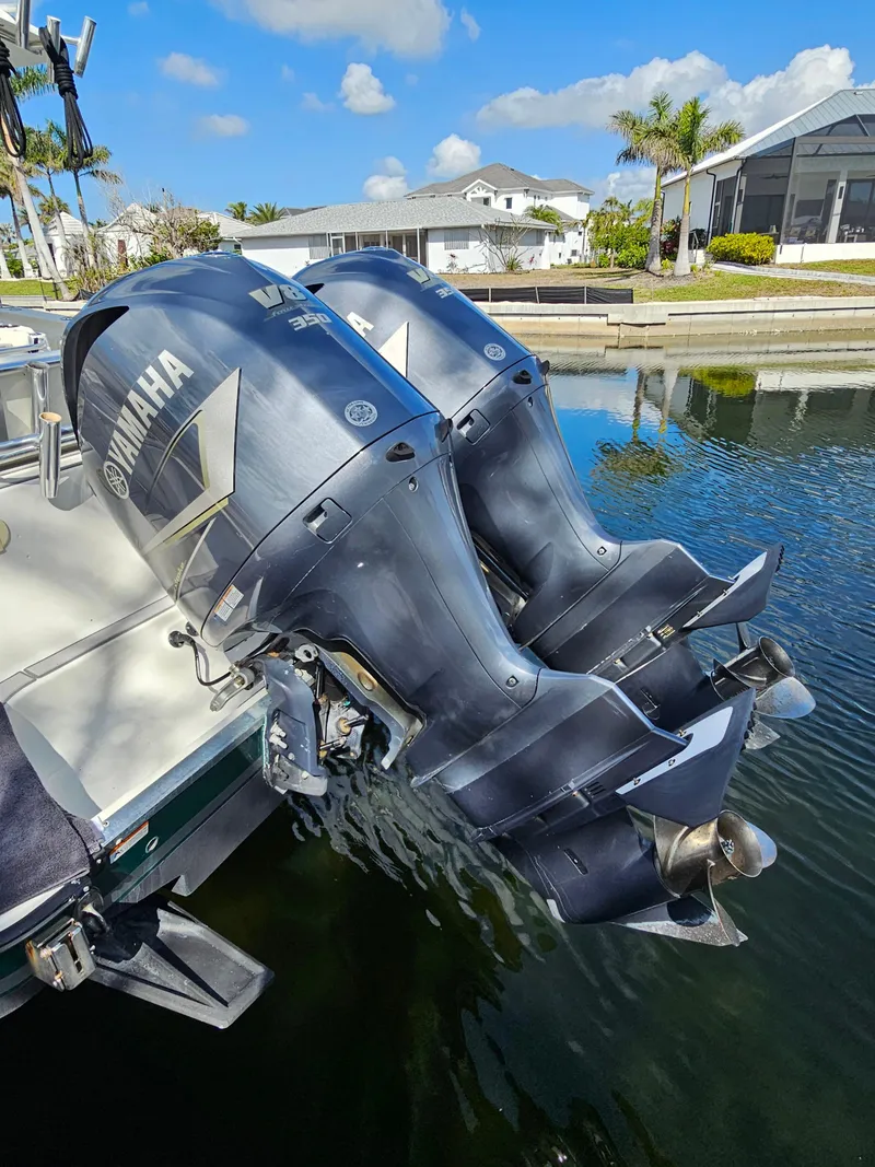 Slide: The Image of 2006 Hydra-Sports Vector 3300 CC with twin Yamaha outboard engines in a scenic marina. - 3