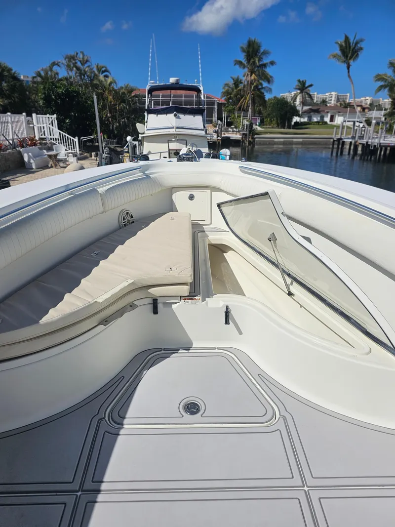 Slide: The Image of 2006 Hydra-Sports Vector 3300 CC boat interior with seating and storage, docked under clear skies. - 6