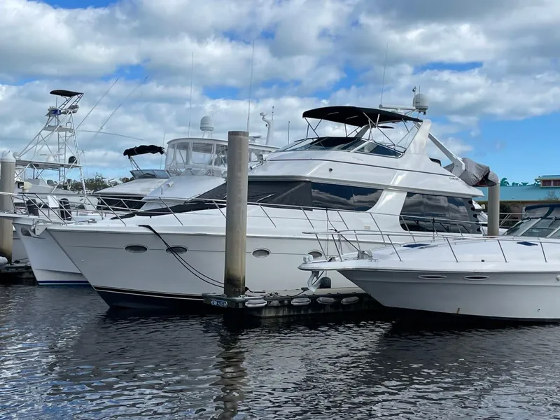 Slide: The Image of 1998 Carver 530 Voyager Pilothouse yacht docked at marina under cloudy sky. - 15