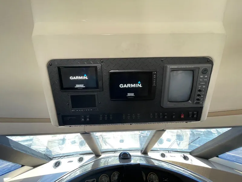 Slide: The Image of 1998 Carver 530 Voyager Pilothouse dashboard with Garmin navigation displays. - 22