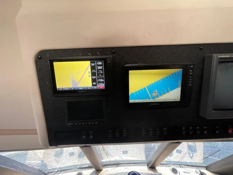 Slide: The Image of 1998 Carver 530 Voyager Pilothouse dashboard with navigation screens and controls. - 23