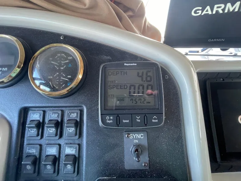 Slide: The Image of 1998 Carver 530 Voyager Pilothouse dashboard with depth and speed gauges. - 24