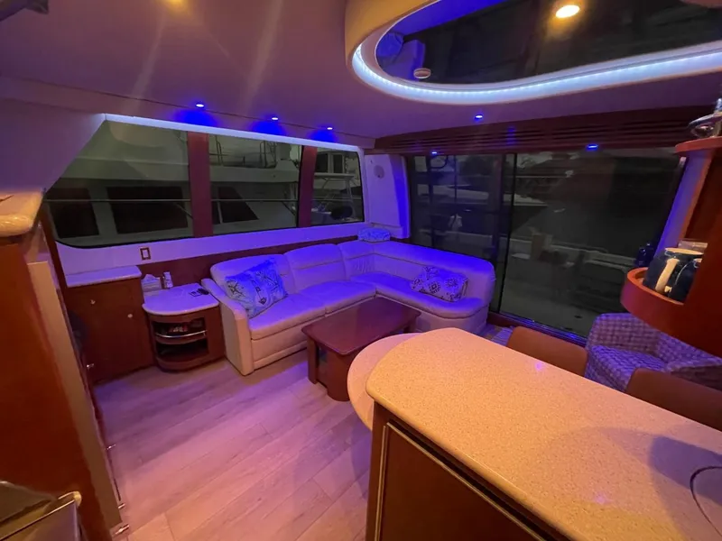 Slide: The Image of Luxurious interior of 1998 Carver 530 Voyager Pilothouse with ambient lighting and plush seating. - 28