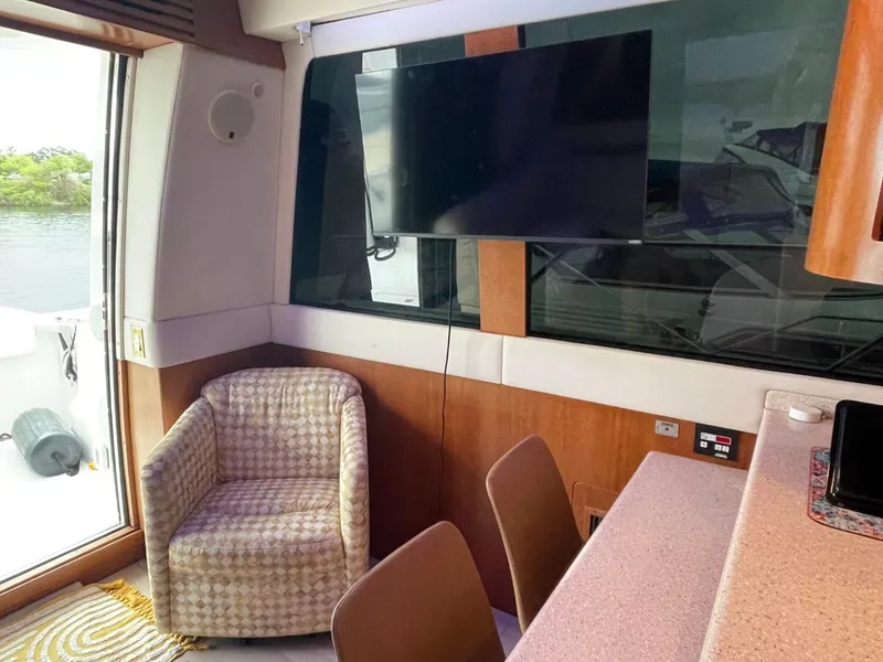 Slide: The Image of Interior of 1998 Carver 530 Voyager Pilothouse with TV, chair, and table. - 31