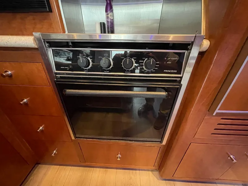 Slide: The Image of Oven in 1998 Carver 530 Voyager Pilothouse kitchen with wooden cabinetry. - 38