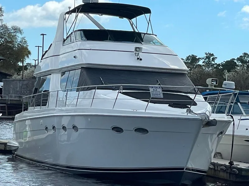 Slide: The Image of 1998 Carver 530 Voyager Pilothouse yacht docked at marina under blue sky. - 5