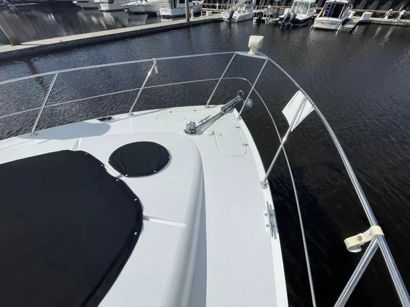 Slide: The Image of 1998 Carver 530 Voyager Pilothouse yacht docked at marina, view of bow and railing. - 12