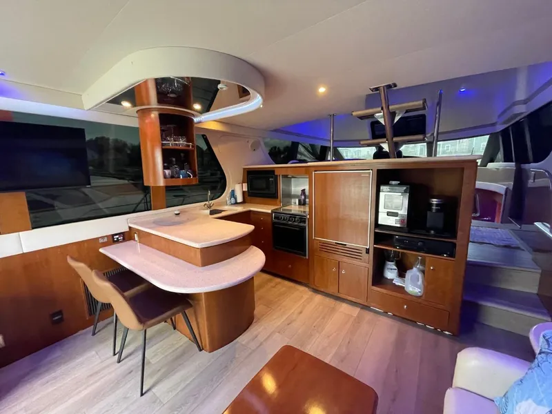 Slide: The Image of Interior of 1998 Carver 530 Voyager Pilothouse yacht with modern kitchen and seating area. - 32