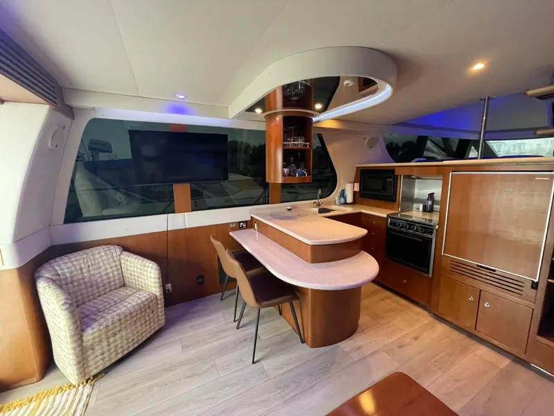 Slide: The Image of Interior of 1998 Carver 530 Voyager Pilothouse with modern kitchen and seating area. - 33
