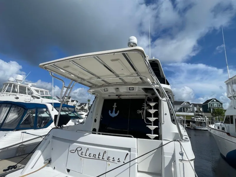 Slide: The Image of 1998 Carver 530 Voyager Pilothouse yacht docked under a cloudy sky. - 4