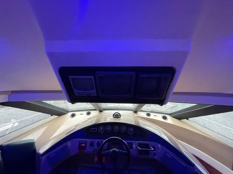 Slide: The Image of Interior view of 1998 Carver 530 Voyager Pilothouse helm with blue lighting. - 44