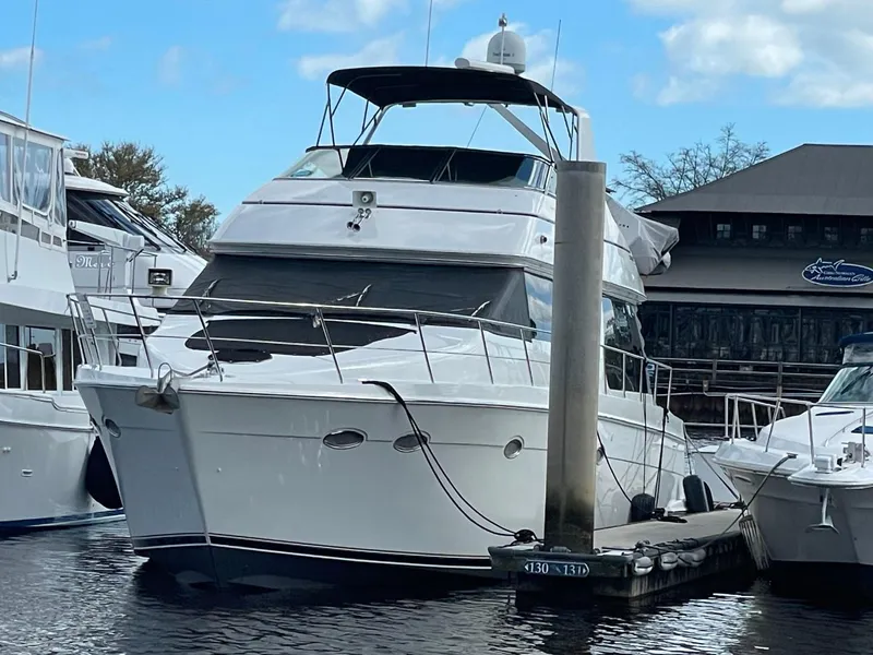 Slide: The Image of 1998 Carver 530 Voyager Pilothouse yacht docked at marina. - 7