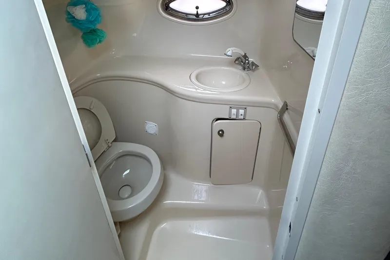 Slide: The Image of 2005 Sea Ray 290 Amberjack boat interior with white seating and steering console. - 4