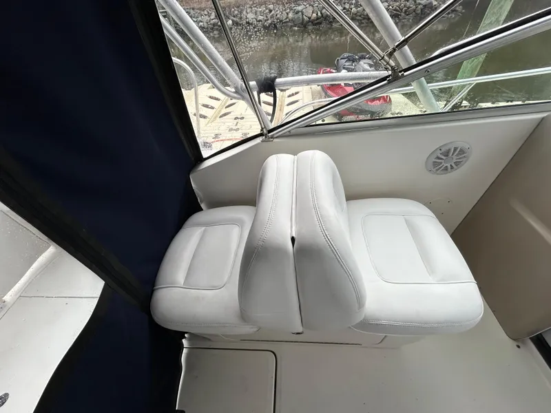Slide: The Image of Interior of 2005 Sea Ray 290 Amberjack boat, featuring cozy seating and sleeping area. - 6