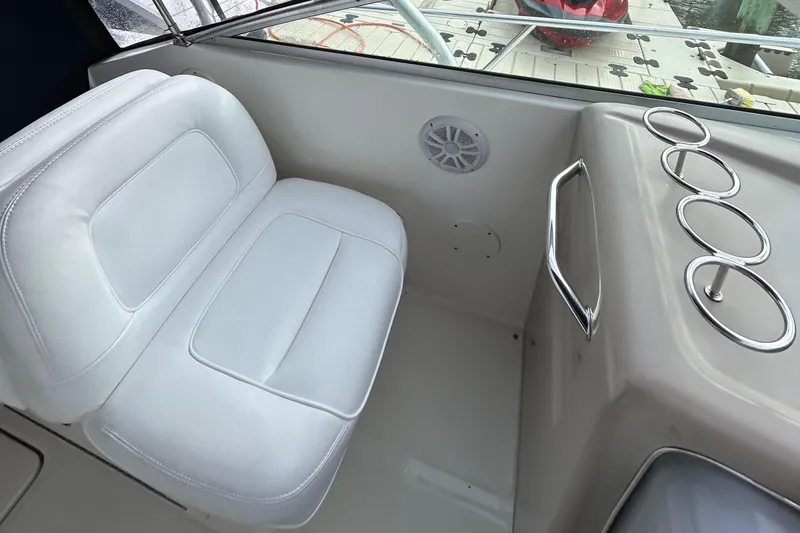 Slide: The Image of 2005 Sea Ray 290 Amberjack cabin interior with bed and portholes. - 7