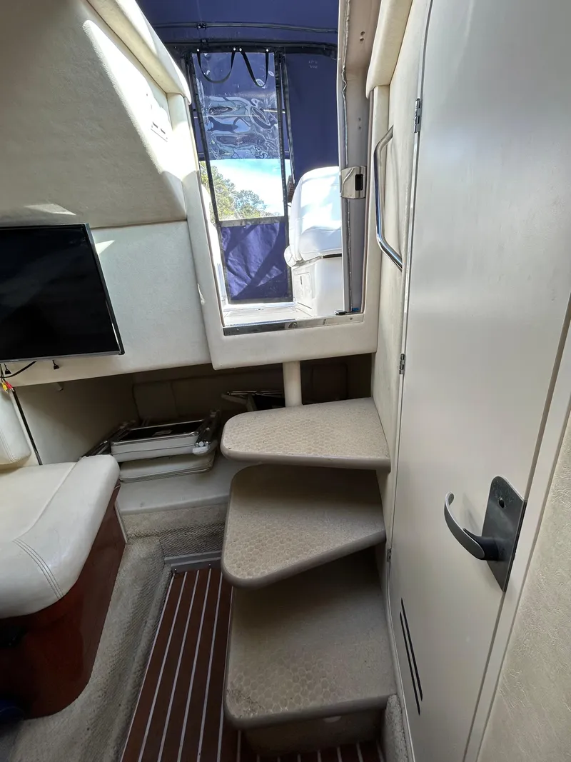 Slide: The Image of Interior of 2005 Sea Ray 290 Amberjack with stairs and seating area. - 9