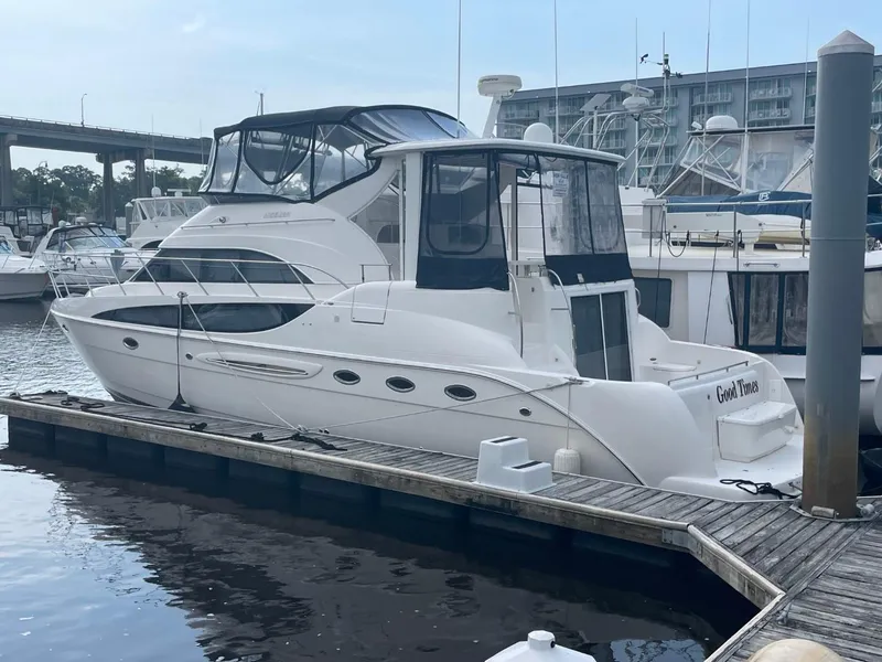 Slide: The Image of 2004 Meridian 459 Motoryacht docked at marina, featuring sleek design and spacious cabin. - 1