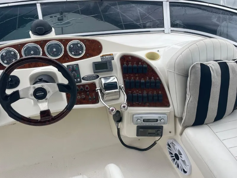 Slide: The Image of 2004 Meridian 459 Motoryacht helm with steering wheel, gauges, and control panel. - 10