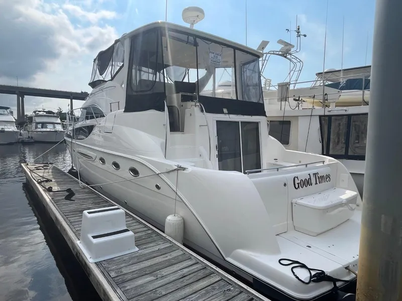 Slide: The Image of 2004 Meridian 459 Motoryacht docked, featuring sleek design and spacious deck area. - 4
