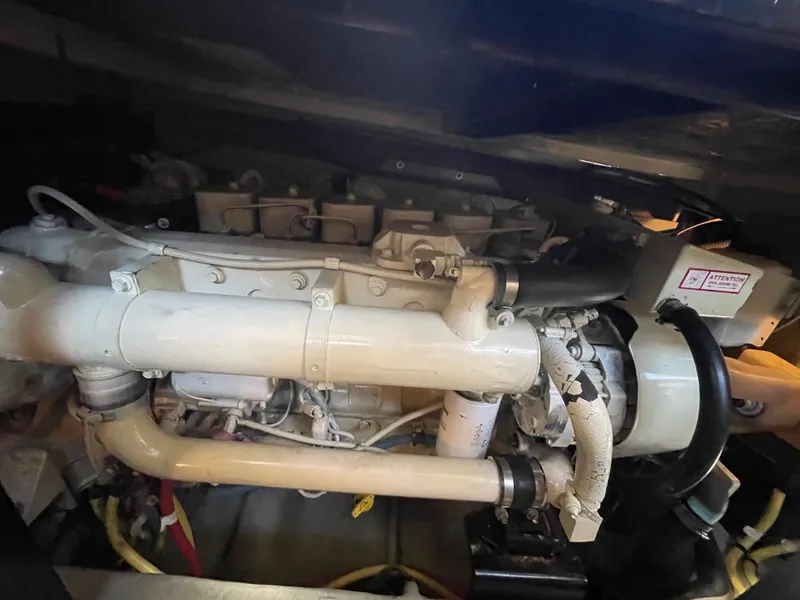 Slide: The Image of Engine compartment of a 2004 Meridian 459 Motoryacht, showcasing mechanical components and piping. - 42