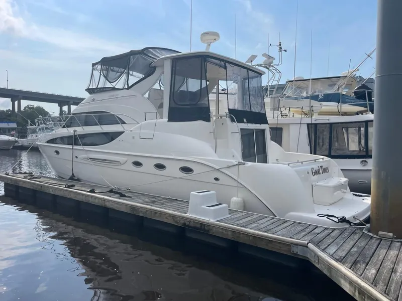 Slide: The Image of 2004 Meridian 459 Motoryacht docked at marina, featuring sleek design and spacious cabin. - 8