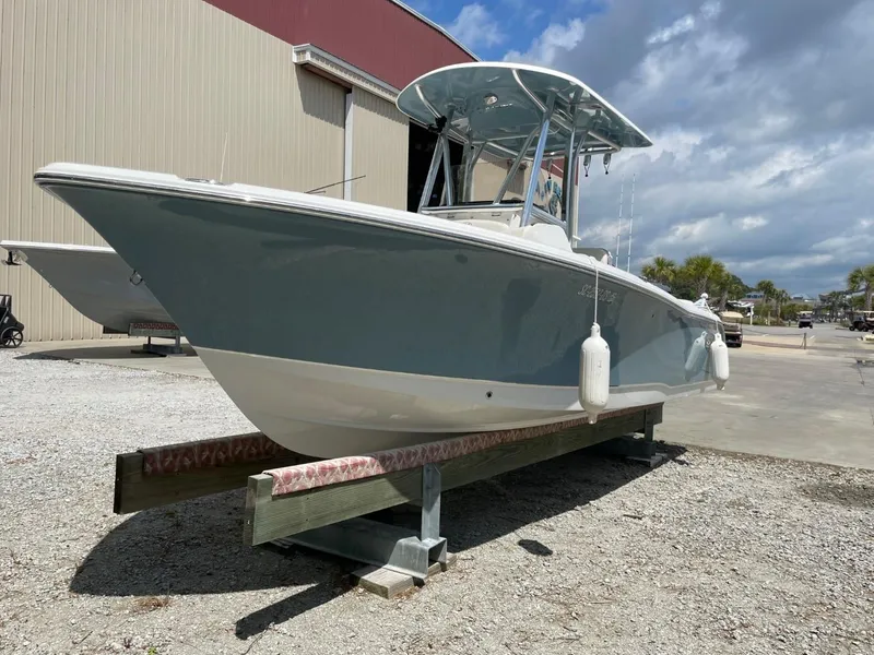 Slide: The Image of 2022 Sea Hunt 234 Ultra boat on display outdoors, under a partly cloudy sky. - 1