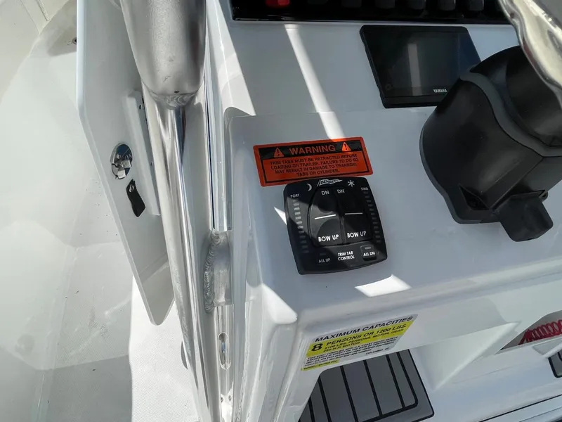 Slide: The Image of Control panel of 2022 Sea Hunt 234 Ultra boat with warning labels and switches. - 18
