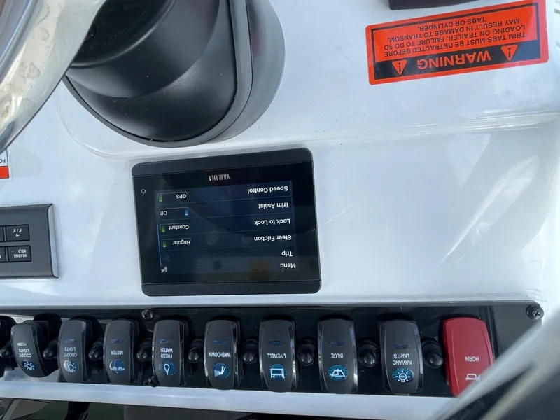 Slide: The Image of Control panel of 2022 Sea Hunt 234 Ultra boat with switches and display screen. - 25