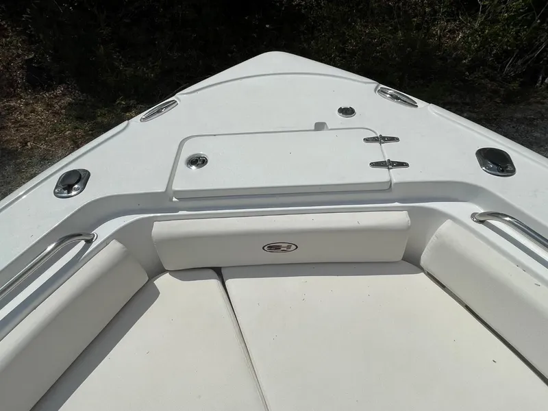 Slide: The Image of 2022 Sea Hunt 234 Ultra boat bow with cushioned seating and storage hatch. - 28