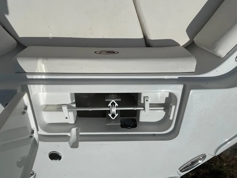 Slide: The Image of 2022 Sea Hunt 234 Ultra boat storage compartment with open lid and visible latch mechanism. - 30