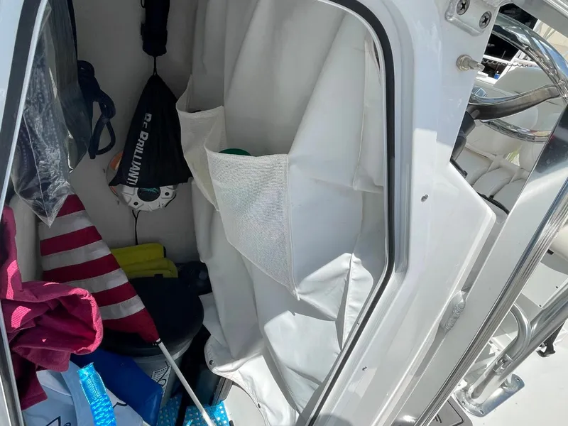 Slide: The Image of Storage compartment in a 2022 Sea Hunt 234 Ultra boat, featuring various boating accessories. - 33