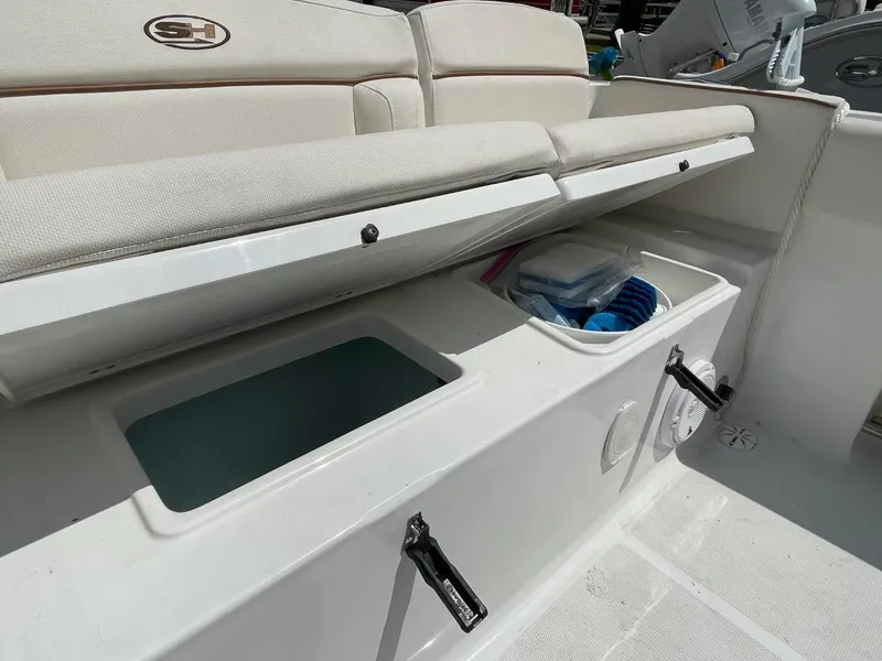 Slide: The Image of 2022 Sea Hunt 234 Ultra boat storage compartments with cushioned seating. - 36