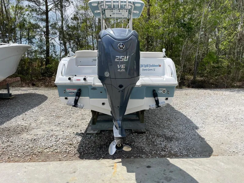 Slide: The Image of 2022 Sea Hunt 234 Ultra boat with Yamaha 250 V6 engine, parked outdoors. - 6