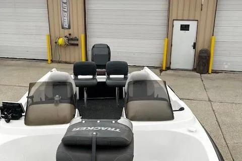 Slide: The Image of 2001 Bass Tracker TARGA 1900 Fiberglass Walleye Boat, parked near garage doors. - 11