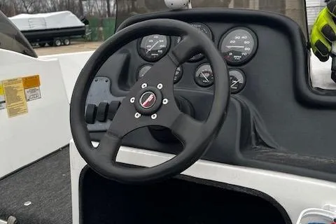 Slide: The Image of 2001 Bass Tracker TARGA 1900 boat dashboard with steering wheel and gauges. - 12
