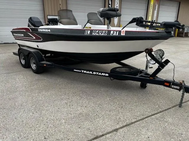 Slide: The Image of 2001 Bass Tracker TARGA 1900 Fiberglass Walleye Boat on trailer, parked outdoors. - 2
