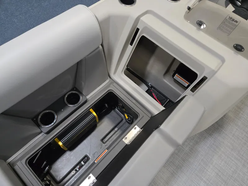 Slide: The Image of 2025 Princecraft Sportfisher 21-2RS boat interior with storage compartments and cup holders. - 10
