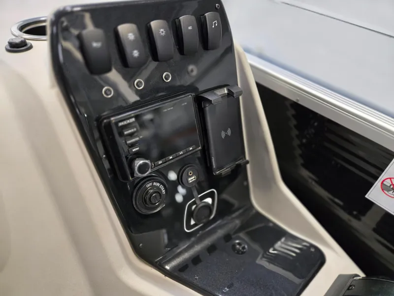 Slide: The Image of Control panel of 2025 Princecraft Sportfisher 21-2RS boat with switches and display. - 12