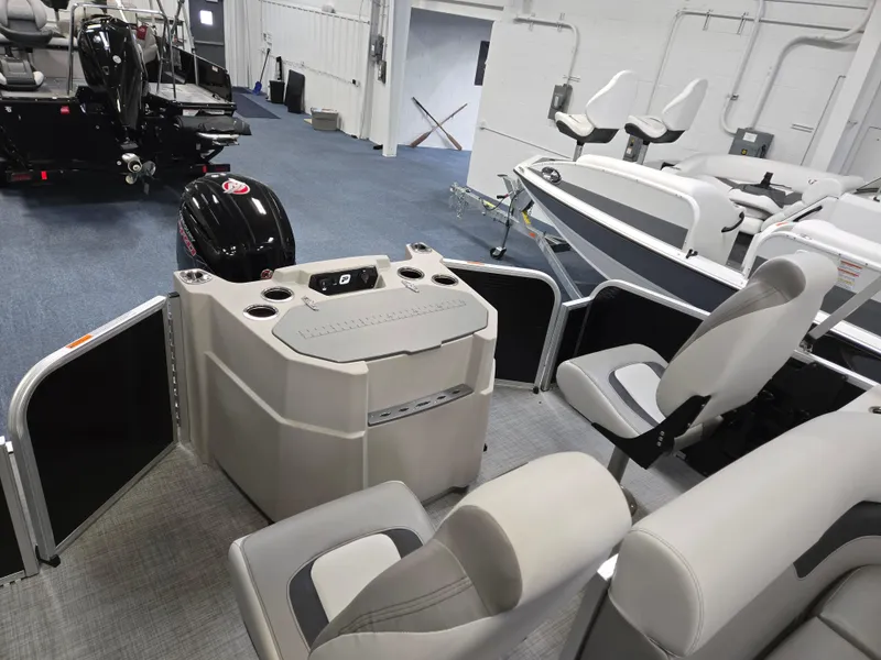 Slide: The Image of 2025 Princecraft Sportfisher 21-2RS interior with seating and motor in showroom. - 14