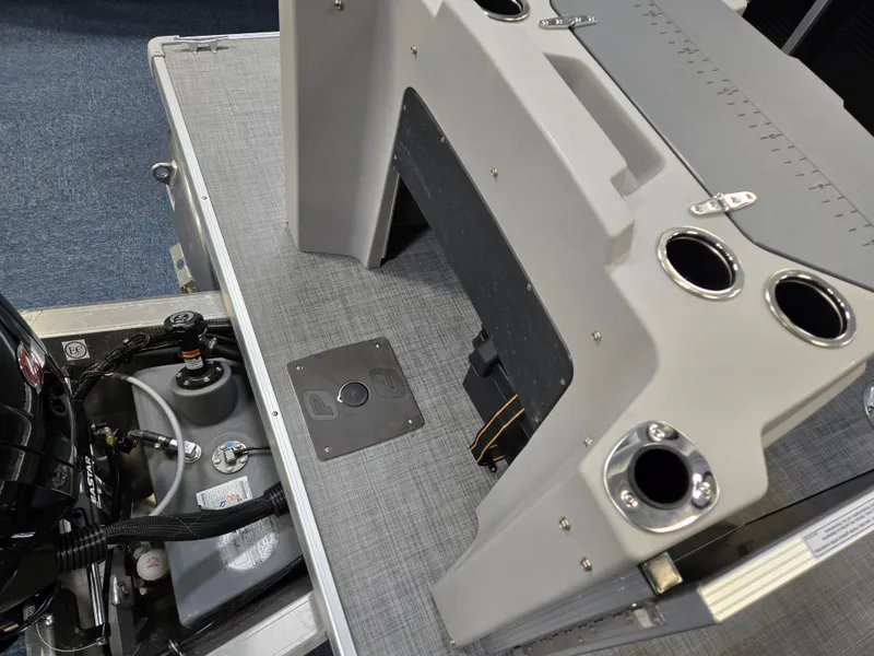 Slide: The Image of 2025 Princecraft Sportfisher 21-2RS boat interior with motor and cup holders. - 4