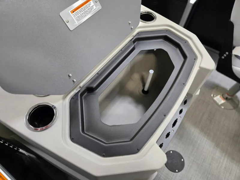 Slide: The Image of 2025 Princecraft Sportfisher 21-2RS boat interior with open storage compartment and cup holders. - 5