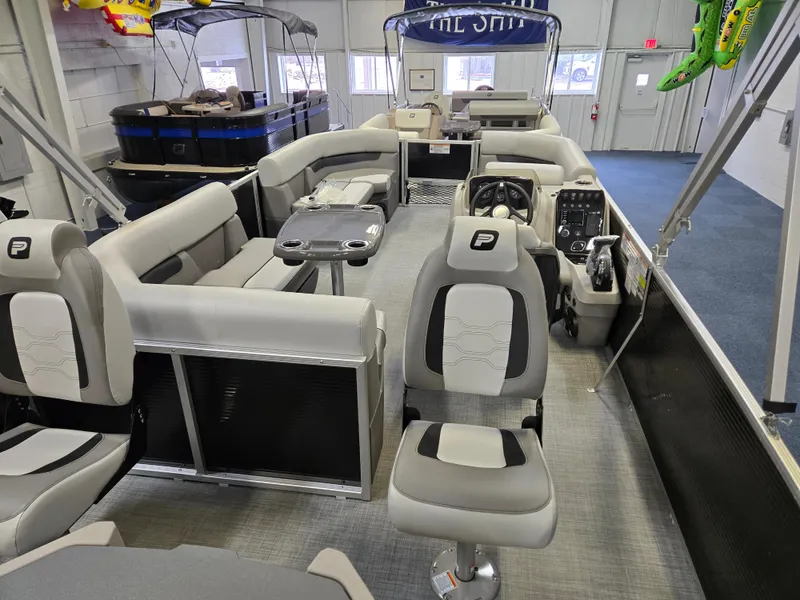 Slide: The Image of 2025 Princecraft Sportfisher 21-2RS pontoon boat interior with seating and control console. - 6