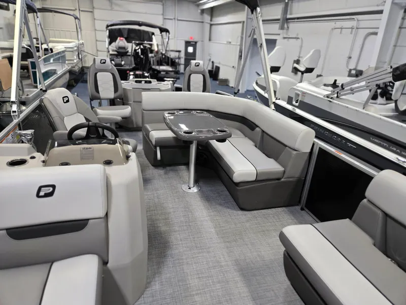 Slide: The Image of 2025 Princecraft Sportfisher 21-2RS pontoon boat interior with seating and table. - 7
