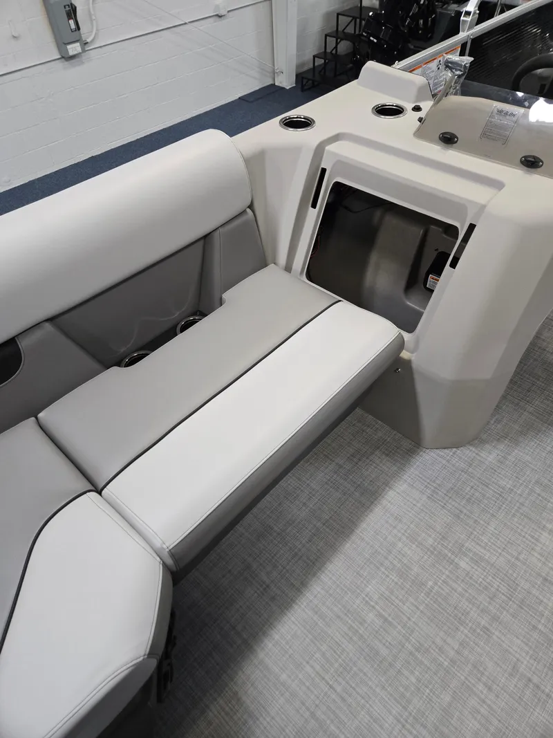 Slide: The Image of 2025 Princecraft Sportfisher 21-2RS boat interior with gray seating and storage compartment. - 8