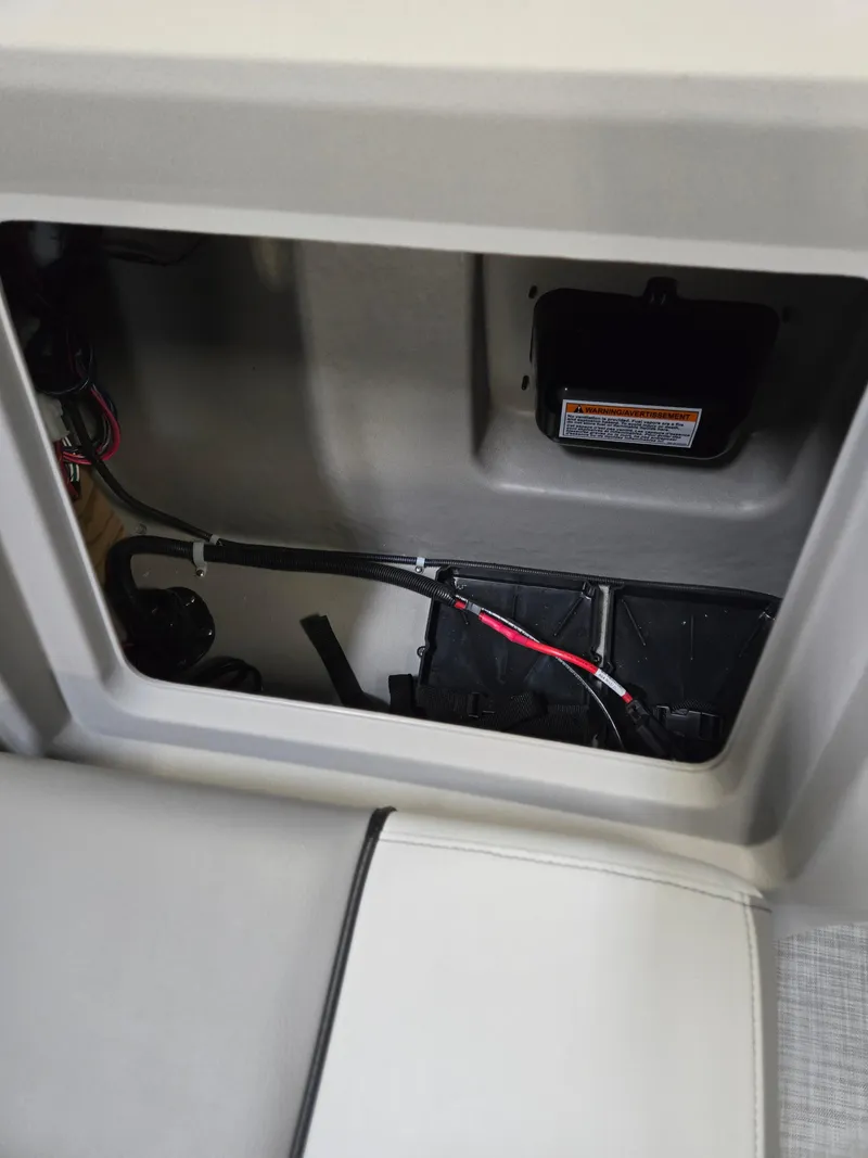 Slide: The Image of Interior compartment of 2025 Princecraft Sportfisher 21-2RS boat, showing wiring and storage space. - 9