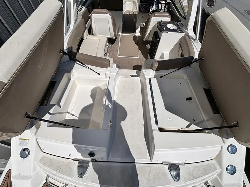 Slide: The Image of 2013 Sea Ray 250 SLX boat interior with open storage compartments and seating. - 10