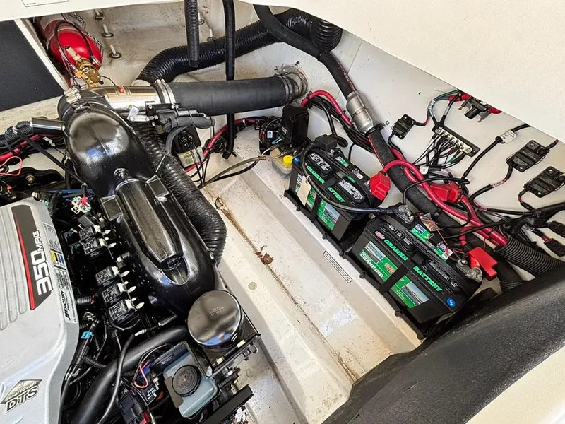 Slide: The Image of Engine compartment of a 2013 Sea Ray 250 SLX boat, featuring batteries and wiring. - 13