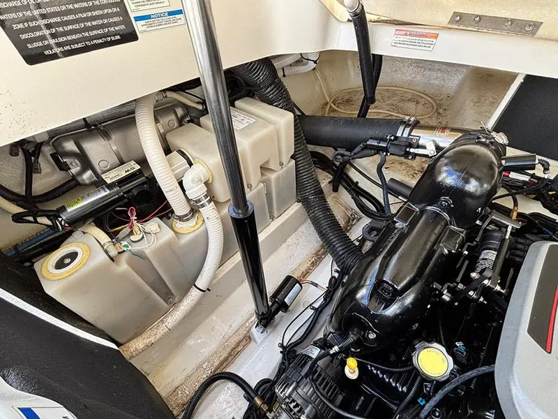 Slide: The Image of Engine compartment of a 2013 Sea Ray 250 SLX boat, showcasing mechanical components. - 14