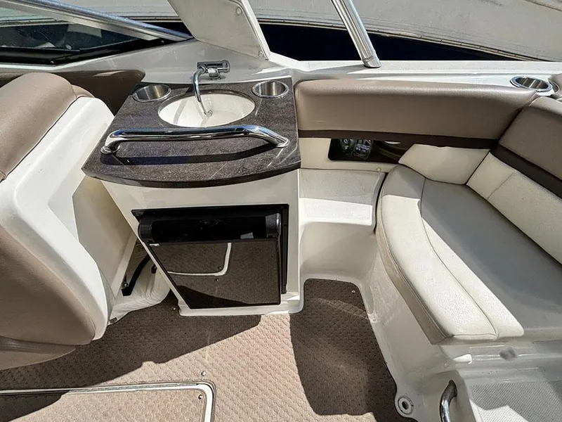 Slide: The Image of 2013 Sea Ray 250 SLX boat interior with sink and seating area. - 17