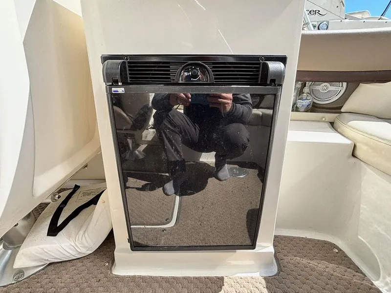 Slide: The Image of Built-in refrigerator on a 2013 Sea Ray 250 SLX boat interior. - 18